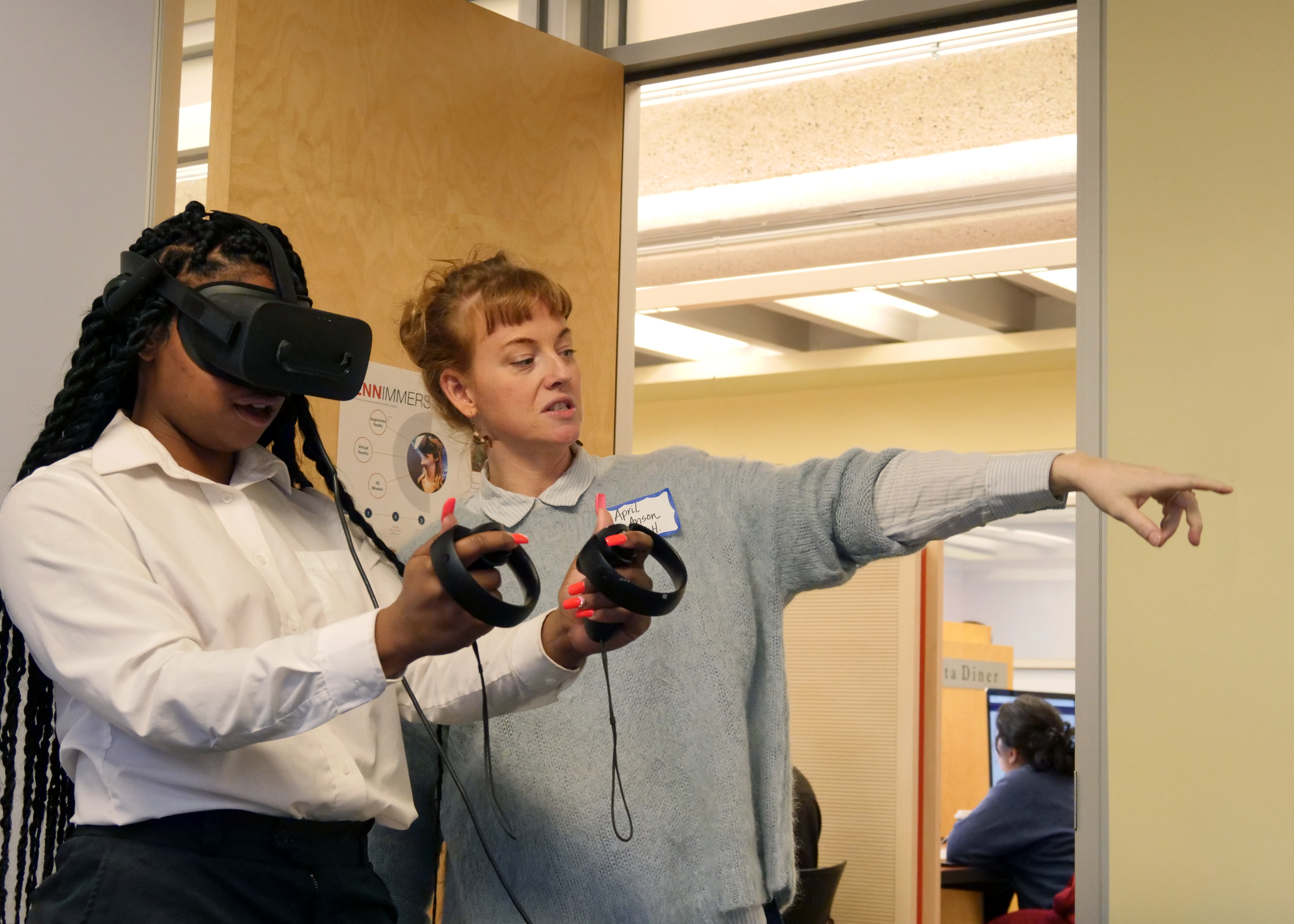 April Anson shows a participant how to use VR controls