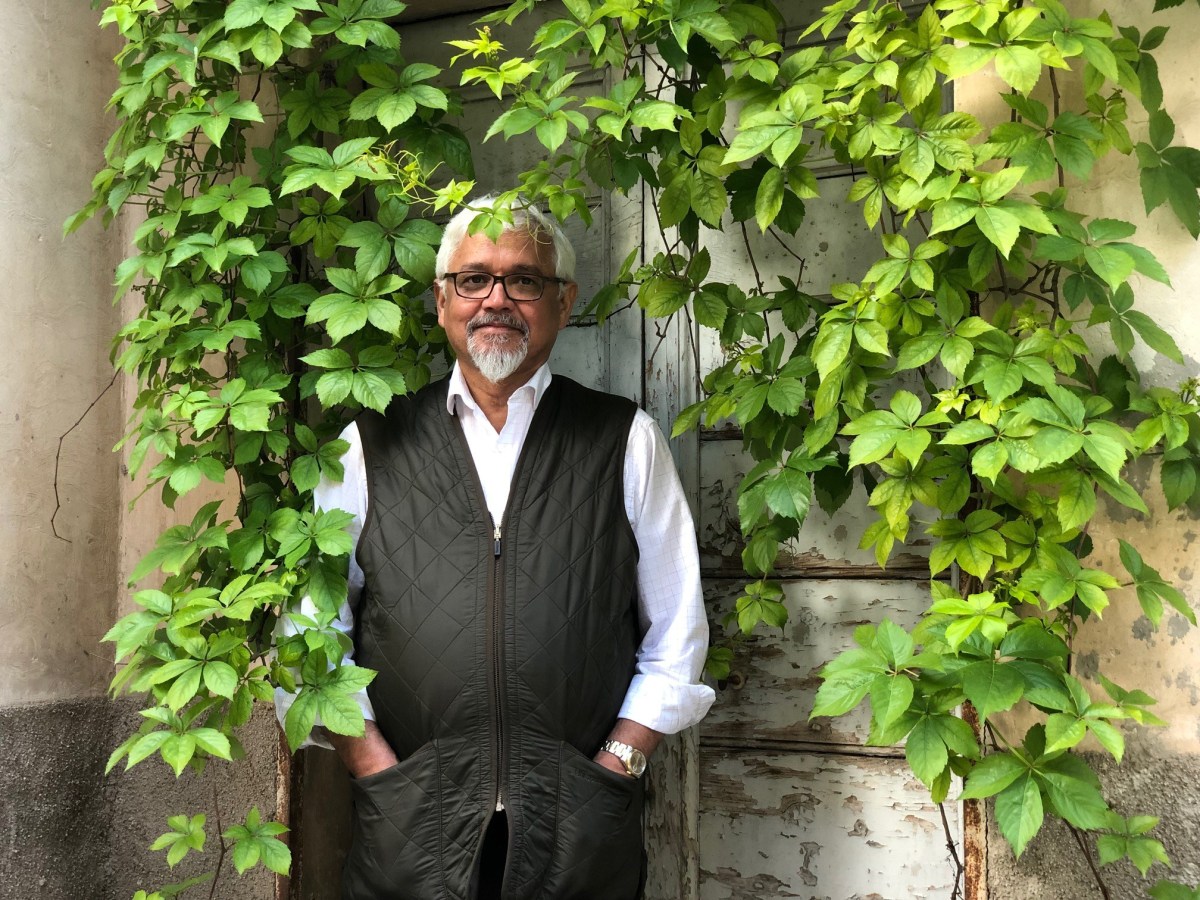 amitav ghosh against a wall with ivy