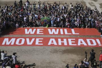 Participants at COP22, a follow-up on the Paris climate agreement, stage a public show of support for climate negotiations in Marrakech, Morocco, on Nov. 18. (AP Photo/David Keyton)